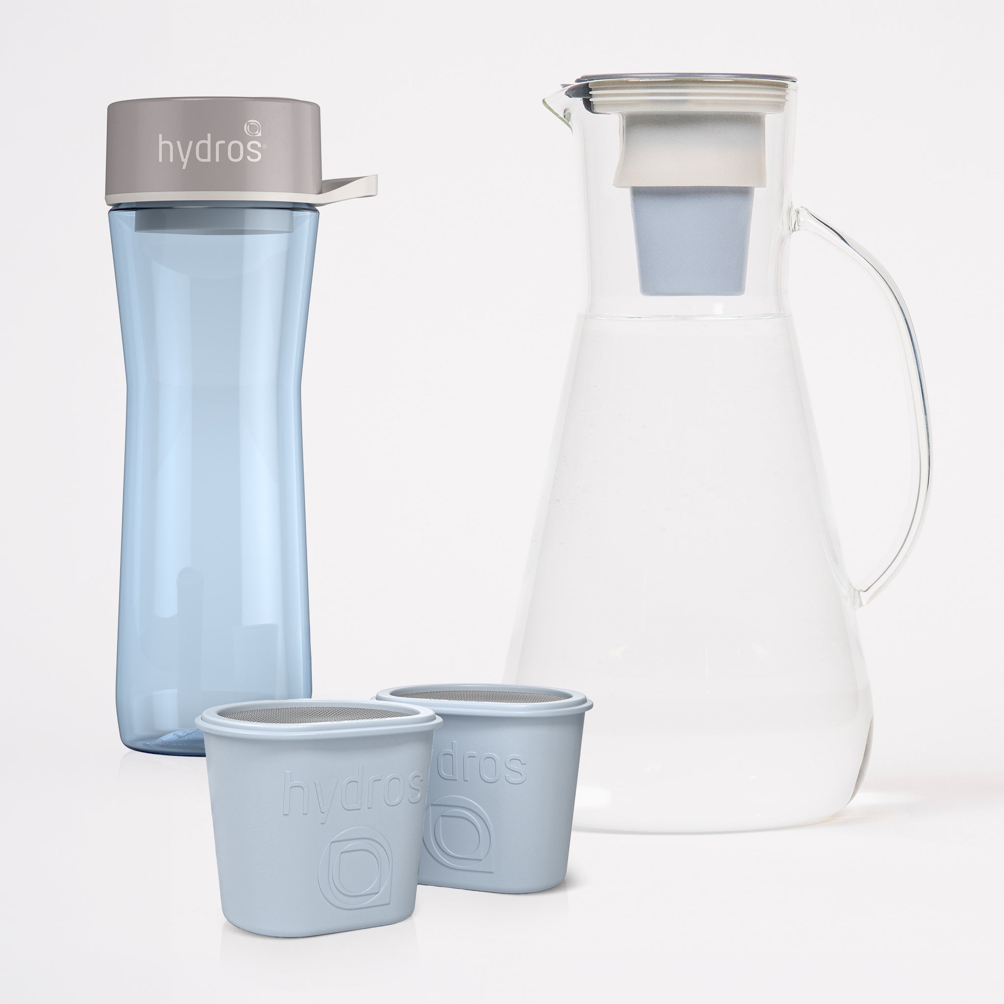 Hydros water bottle and matching glass carafe with two small cups on a clean white background.